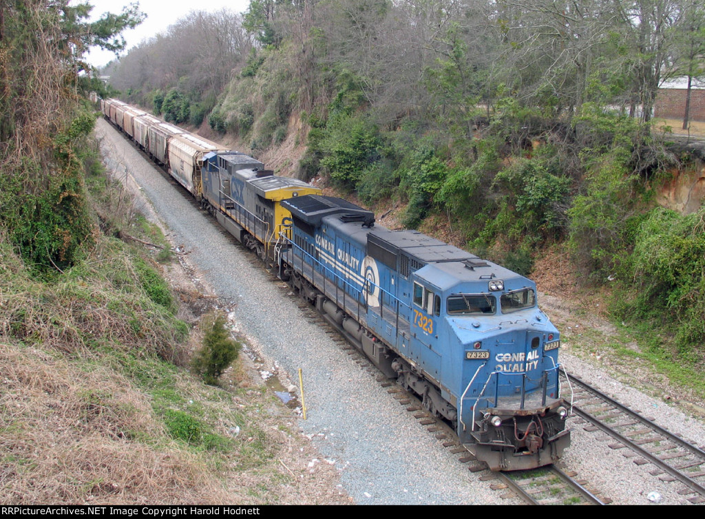 CSX 7323 leads a grain train held at Rice Street